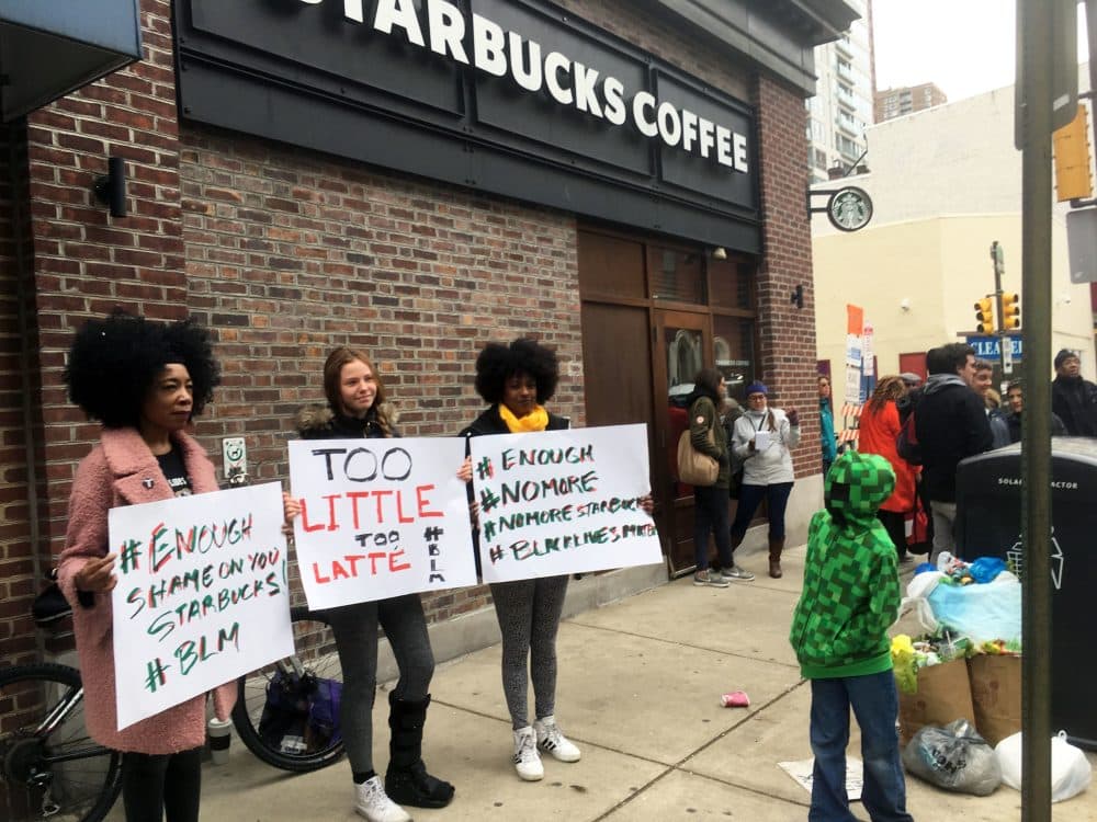 Protesters gather outside a Starbucks in Philadelphia, Sunday, April 15, 2018, where two black men were arrested Thursday after Starbucks employees called police to say the men were trespassing. The arrest prompted accusations of racism on social media. Starbucks CEO Kevin Johnson posted a lengthy statement Saturday night, calling the situation &quot;disheartening&quot; and that it led to a &quot;reprehensible&quot; outcome. (AP Photo/Ron Todt)