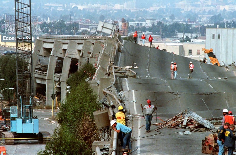 FILE - In this Oct. 19, 1989 file photo, workers check the damage to Interstate 880 in Oakland, Calif., after it collapsed during the Loma Prieta earthquake two days earlier that killed 63 people, injured almost 3,800 and caused up to $10 billion damage. (Paul Sakuma/AP)