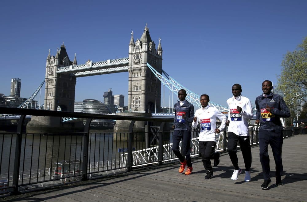 Kenya's Daniel Wanjiru, Ethiopia's Kenenisa Bekele, Kenya's Eliud Kipchoge and Ethiopia's Guye Adola pose for a picture in front of Tower Bridge during the media day at the Tower Hotel, London, Thursday, April 19, 2018. The London Marathon will be raced Sunday. (Steven Paston/PA via AP)