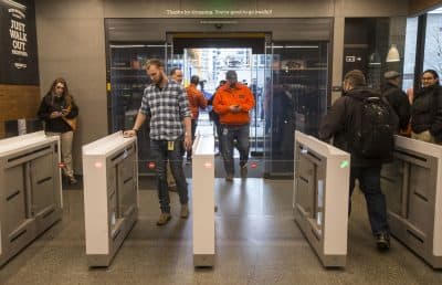 Shoppers enter and check out with purchases at the Amazon Go, on Jan. 22, 2018 in Seattle. After more than a year in beta, Amazon opened the cashierless store to the public. (Stephen Brashear/Getty Images)