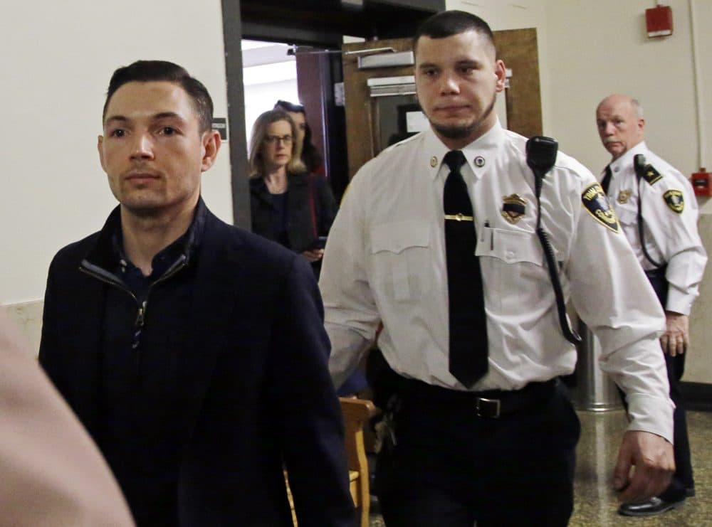 Bryon Hefner, the estranged husband of former Massachusetts Senate President Stan Rosenberg, is escorted out of court after his arraignment at Suffolk Superior Court on April 24, 2018, in Boston. (Elise Amendola/AP)