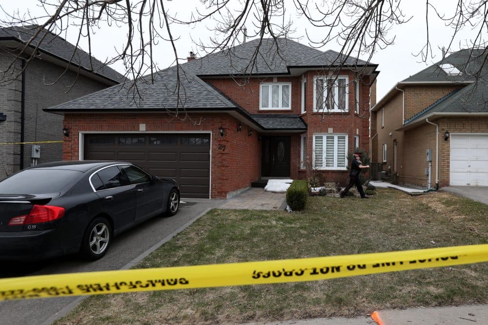 A police oficer walks around Alek Minassian's house in Richmond Hill, Ontario, on April 24, 2018. (Lars Hagberg/AFP/Getty Images)