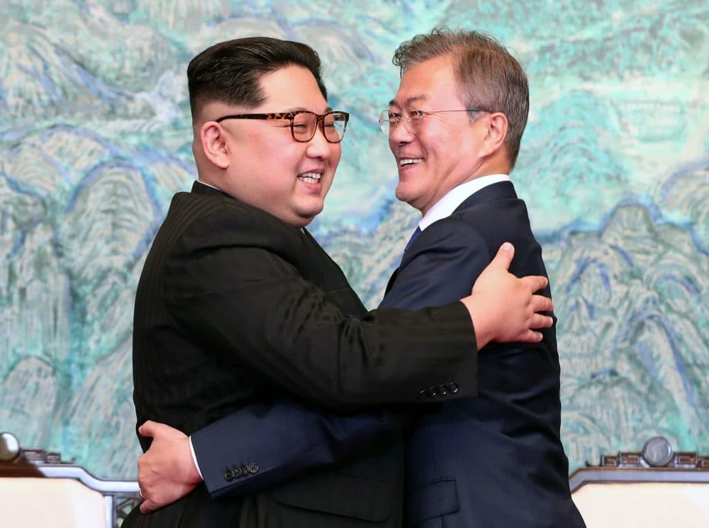 North Korea's leader Kim Jong Un (left) and South Korea's President Moon Jae-in (right) hug during a signing ceremony near the end of their historic summit at the truce village of Panmunjom on April 27, 2018. (Korea Summit Press Pool/AFP/Getty Images)