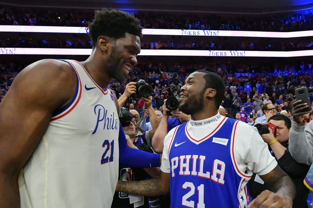 Joel Embiid celebrates with the newly released Meek Mill after the 76ers clinched their first round series against the Miami Heat. (Photo by Drew Hallowell/Getty Images)