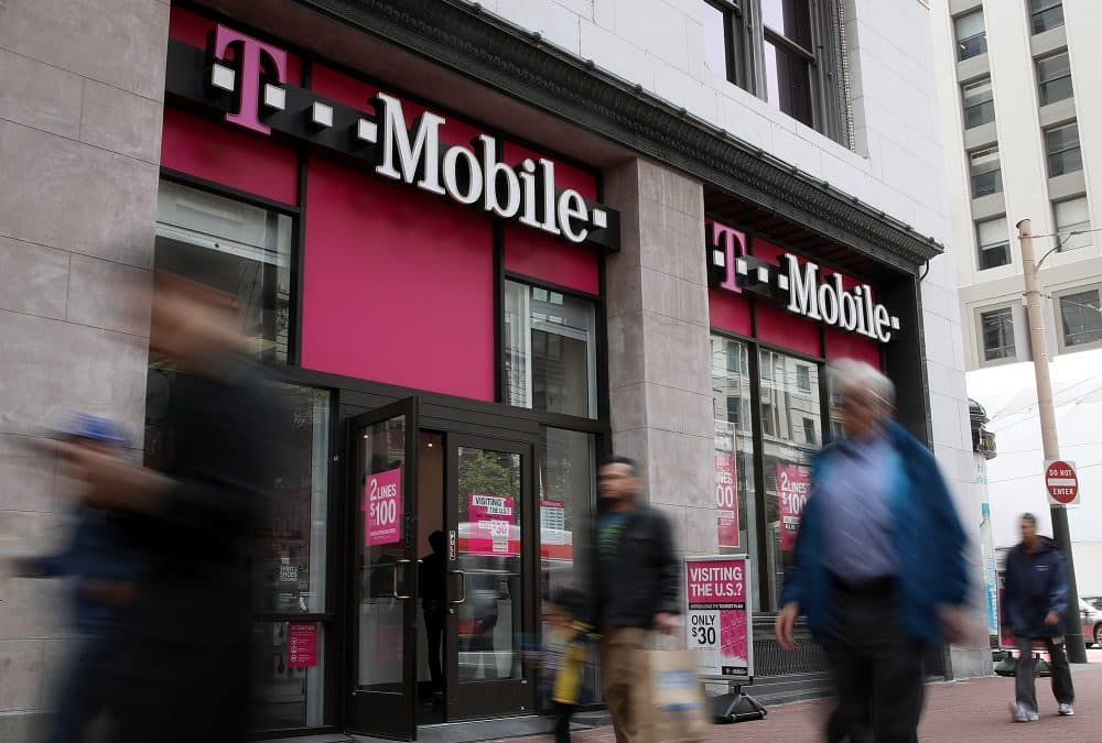Pedestrians walk by a T-Mobile store on April 24, 2017 in San Francisco. (Justin Sullivan/Getty Images)
