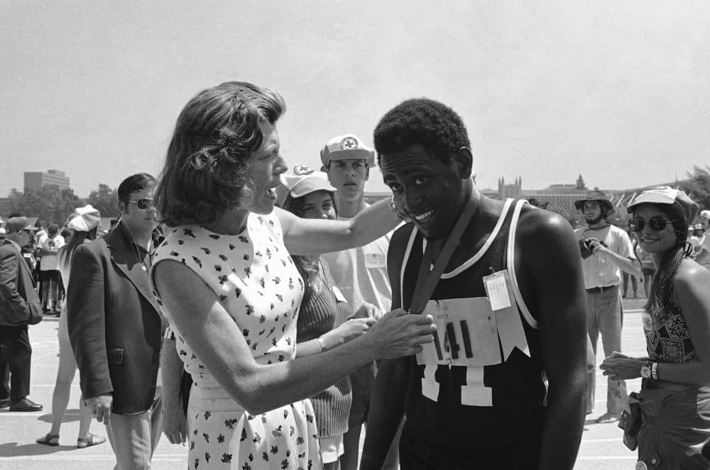 Adonis Brown of Baltimore, Md. smiles as Mrs. Eunice Kennedy Shriver hangs a gold medal around his neck in Aug. 17, 1972 at the International Special Olympics. (Wally Fong/AP)