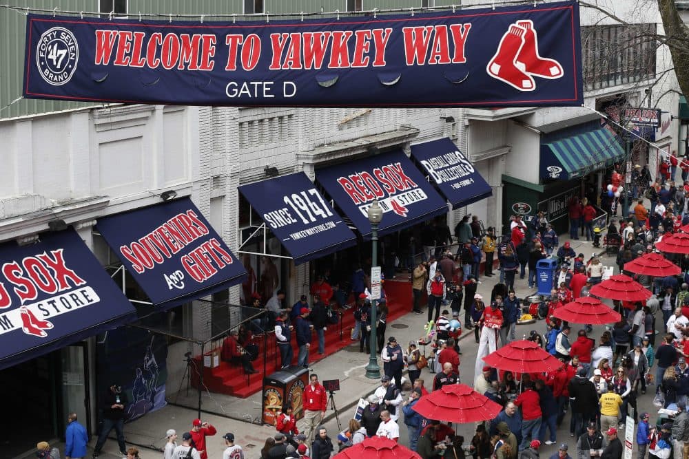 FILE - In this April 4, 2014 file photo, fans enjoy pre-game festivities along Yawkey Way outside Fenway Park in Boston. Boston Red Sox principal owner John Henry says he wants to take steps to rename all of Yawkey Way, a street that has been an enduring reminder of the franchise's complicated racial past. (AP Photo/Michael Dwyer, File)