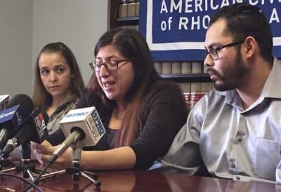 In this Feb. 14, 2018, file photo, Lilian Calderon, center, cries as she describes her experiences while in custody, alongside her husband, Luis Gordillo, right, during a news conference at the office of the American Civil Liberties Union in Providence, R.I. Calderon was detained by Immigration and Customs Enforcement after an interview designed to confirm her marital relationship. A judge stayed her deportation. The American Civil Liberties Union of Massachusetts filed class action lawsuit, which includes Calderon, Wednesday, April 11, against President Donald Trump over the government's practice of detaining immigrants married to U.S. citizens while they are trying to obtain lawful immigration status. (Michelle R. Smith/AP)