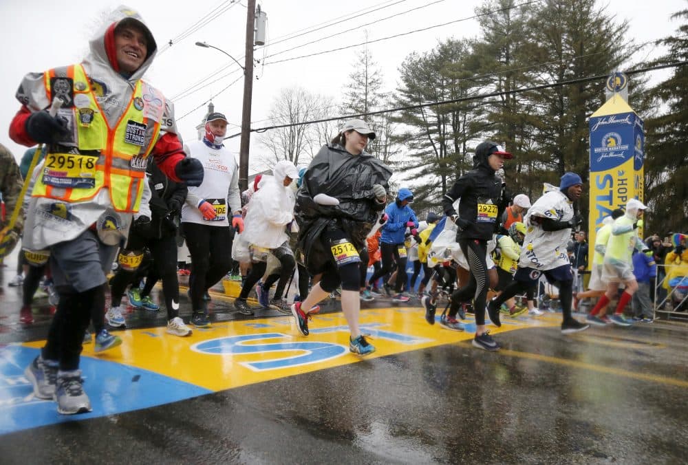 Boston Marathon bombing hero Carlos Arredondo, left, joins others as they break from the start in the mobility impaired runner division of the 122nd running of the marathon on Monday. (Mary Schwalm/AP)