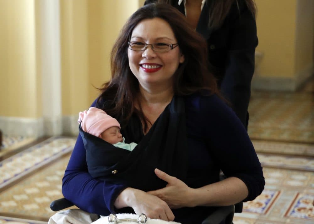 Sen. Tammy Duckworth, D-Ill., carries her baby Maile Pearl Bowlsbey after they went to the Senate floor to vote, on Capitol Hill, Thursday, April 19, 2018 in Washington. (Alex Brandon/AP)