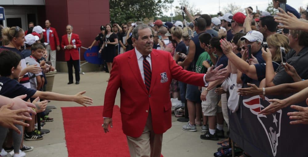 Former New England Patriot announcer Gil Santos outside the Patriots Hall of Fame prior to an NFL football training camp in Foxborough on Aug. 5, 2015. (Charles Krupa/AP)