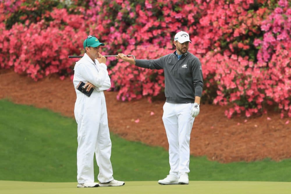 Wesley Bryan talks with his caddie on the 13th hole during a practice round prior to the start of the 2018 Masters. Presumably, &quot;dilly dilly&quot; was not used during their conversation. (Andrew Redington/Getty Images)