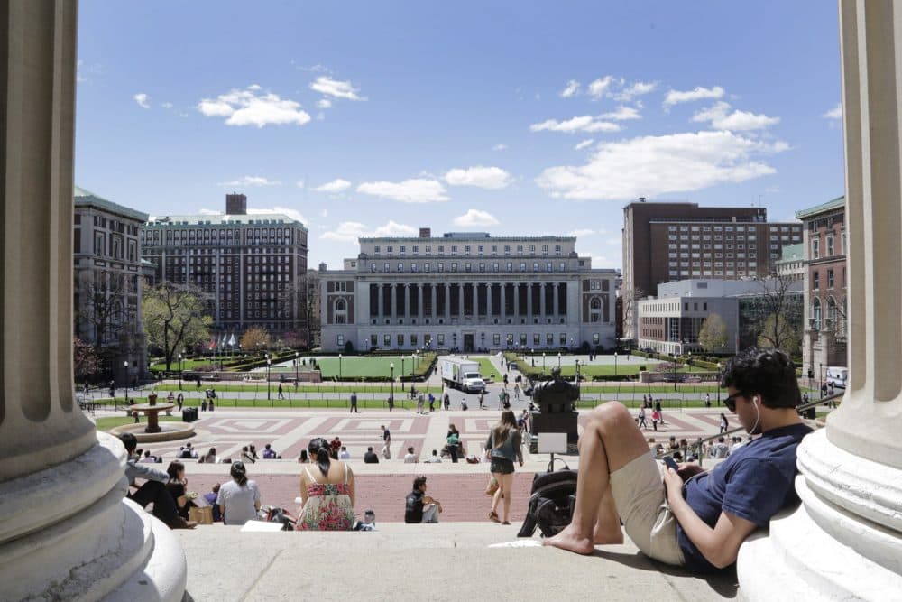 Students sunbathe on the steps of Columbia University's Low Memorial Library, April 29, 2015 in New York. (AP Photo/Mark Lennihan)