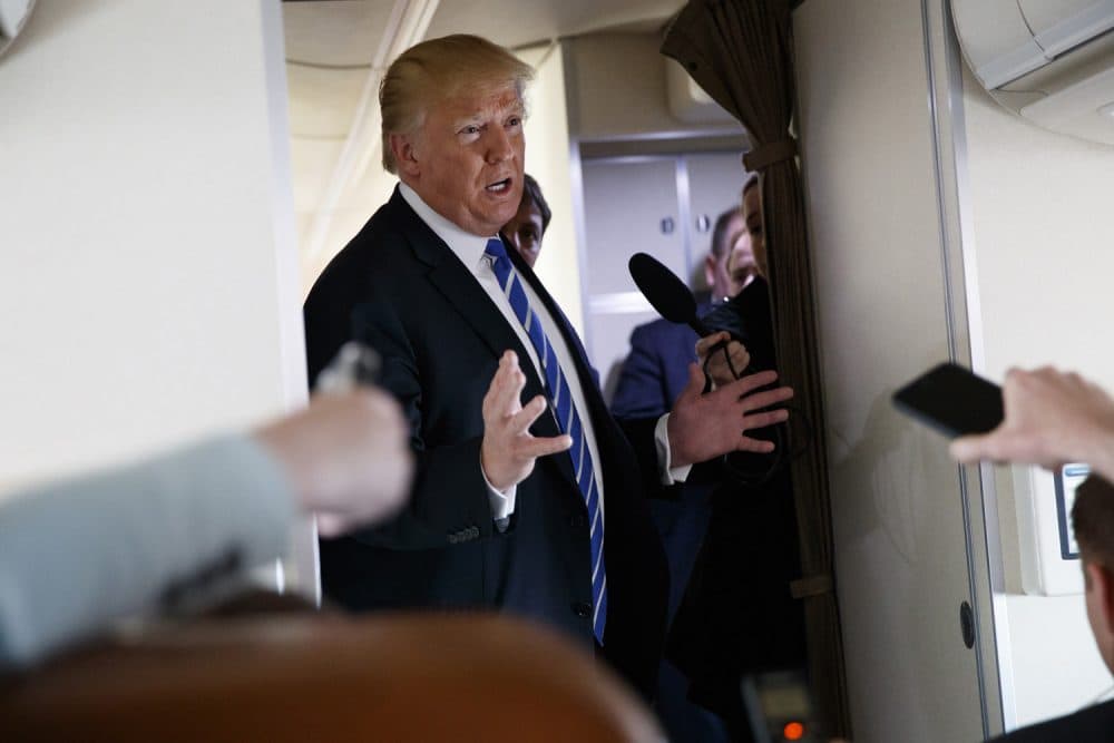 President Donald Trump talks with reporters aboard Air Force One on a flight to Andrews Air Force Base, Md., Thursday, April 5, 2018. (AP Photo/Evan Vucci)