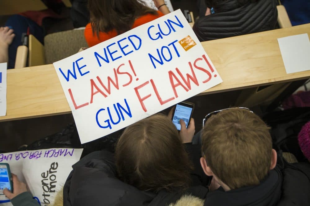 A young couple sits in the Gardner Auditorium at the State House where, one month after the deadly Parkland, Fla. school shooting, Massachusetts students expressed to state legislators their concerns about gun violence. Many called for stricter gun laws. (Jesse Costa/WBUR)