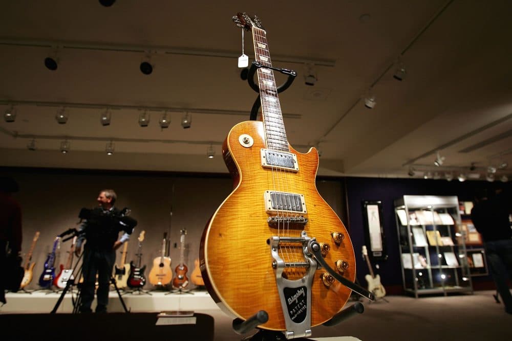 A guitar, once owned and used by Keith Richards of the Rolling Stones, stands on display at Christie's December 10, 2004 in New York City. (Spencer Platt/Getty Images)