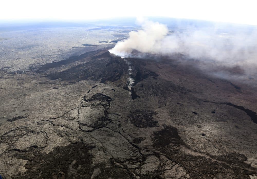 In this photo released by U.S. Geological Survey, ash plume rises above the Puu Oo crater, on Hawaii's Kilaueaa Volcano Thursday, May 3, 2018 in Hawaii Volcanoes National Park. Nearly 1,500 residents were ordered to evacuate from their volcano-side homes after Hawaii's Kilauea Volcano erupted, sending molten lava to chew its way through forest land and bubble up on paved streets. (U.S. Geological Survey via AP)
