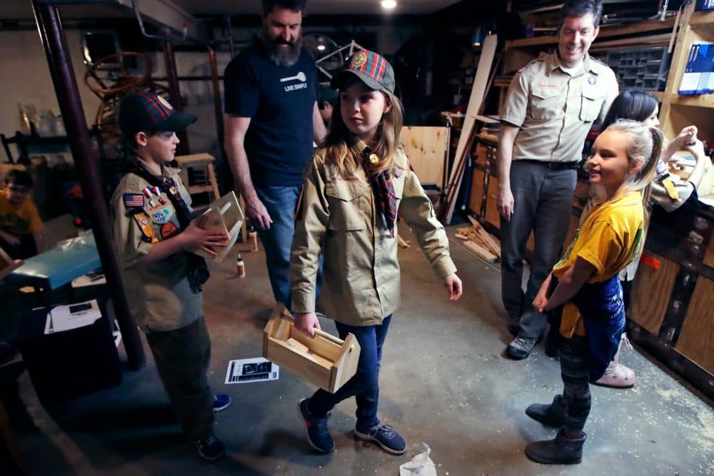 Tatum Weir, center, carries a tool box she built as her twin brother Ian, left, follows after a Cub Scout meeting in Madbury, N.H. With girls soon entering the ranks, the BSA says that iconic name will change to Scouts BSA. The change will take effect in February 2019. (Charles Krupa/AP File)