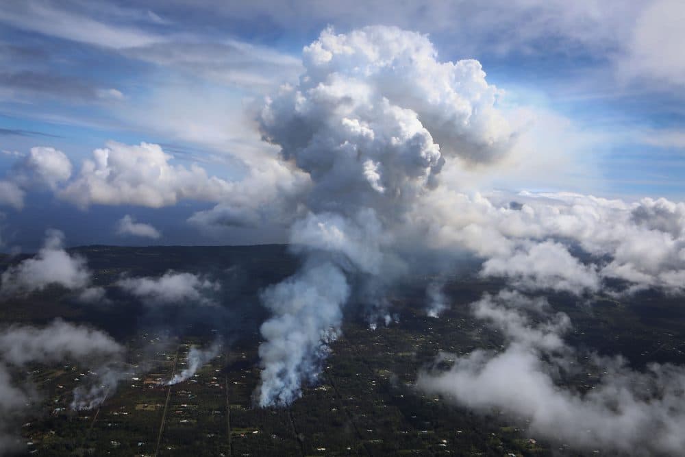 A plume of volcanic gas mixed with smoke from fires caused by lava rises amidst clouds in the Leilani Estates neighborhood, in the aftermath of eruptions from the Kilauea volcano on May 6, 2018 in Pahoa, Hawaii. (Mario Tama/Getty Images)