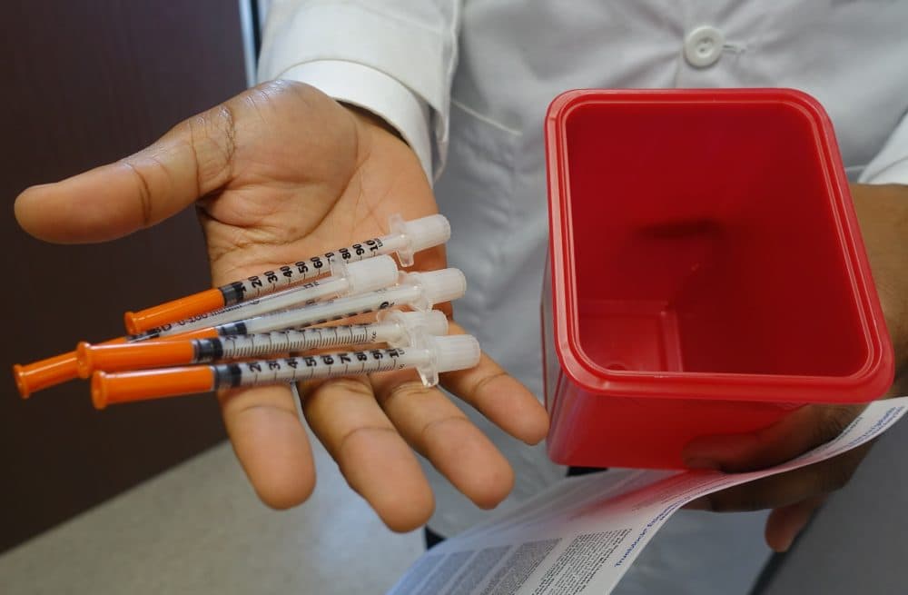 A doctor at the University of Miami holds needles on Nov. 30, 2016, that will be given away to people with drug addictions at a new syringe exchange program. (Kerry Sheridan/AFP/Getty Images)