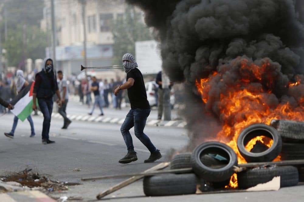 Palestinians clash with Israeli troops following a protest against the U.S. decision to relocate it's Israeli embassy to Jerusalem, in the West Bank city of Bethlehem, Monday, May 14, 2018. (Majdi Mohammed/AP)