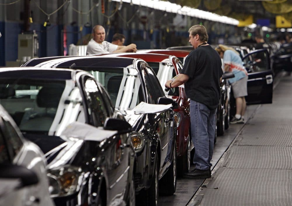 In this Tuesday, June 15, 2010, file photo, workers at General Motors' Lordstown Assembly plant in Lordstown, Ohio, put the final touches on Chevy Cobalts. (Mark Duncan, File/AP)