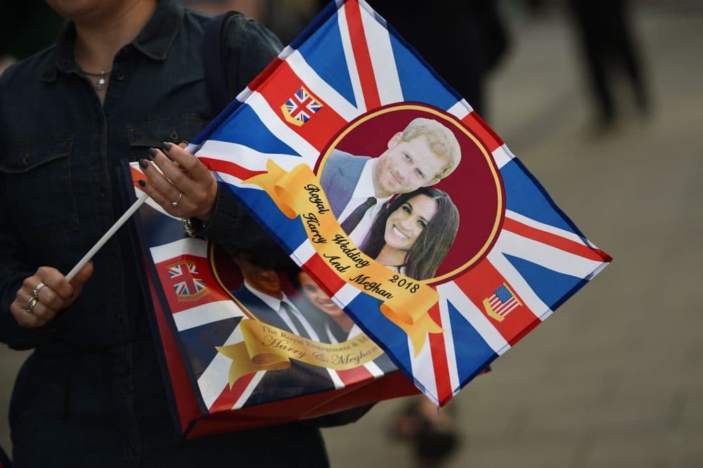A visitor carries a bag featuring Britain's Prince Harry and Meghan Markle in Windsor, England, on May 17, 2018, two days before the royal wedding. (Oli Scarff/AFP/Getty Images)