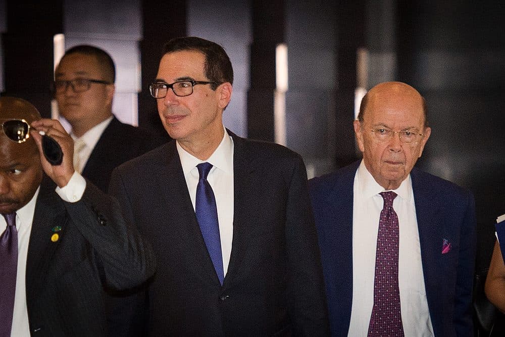 U.S. Treasury Secretary Steven Mnuchin (left) and U.S. Commerce Secretary Wilbur Ross (right) walk through a hotel lobby as they head to the Diaoyutai State Guest House to meet Chinese officials for ongoing trade talks in Beijing on May 4, 2018. (Nicolas Asfouri/AFP/Getty Images)