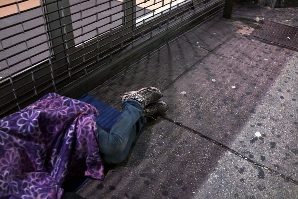 A homeless person sleeps on a Manhattan street on Aug. 22, 2014 in New York City. (Spencer Platt/Getty Images)