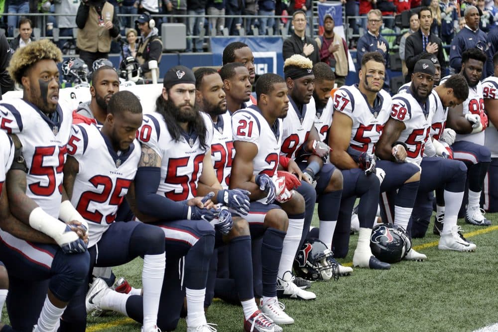 Houston Texans players kneel during the singing of the national anthem before an NFL football game against the Seattle Seahawks, Sunday, Oct. 29, 2017, in Seattle. (Elaine Thompson/AP)