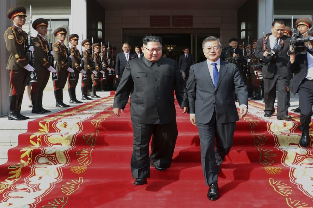 In this May 26, 2018 photo provided on May 27, 2018, by South Korea Presidential Blue House, North Korean leader Kim Jong Un, center left, and South Korean President Moon Jae-in, right, walk after their meeting at the northern side of Panmunjom in North Korea. Moon said Sunday, May 27, that Kim committed in the rivals' surprise meeting to sitting down with President Donald Trump and to a &quot;complete denuclearization of the Korean Peninsula.&quot; The Korean leaders' second summit in a month Saturday, May 26,  saw bear hugs and broad smiles, but their quickly arranged meeting appears to highlight a sense of urgency on both sides of the world's most heavily armed border.  (South Korea Presidential Blue House via AP)