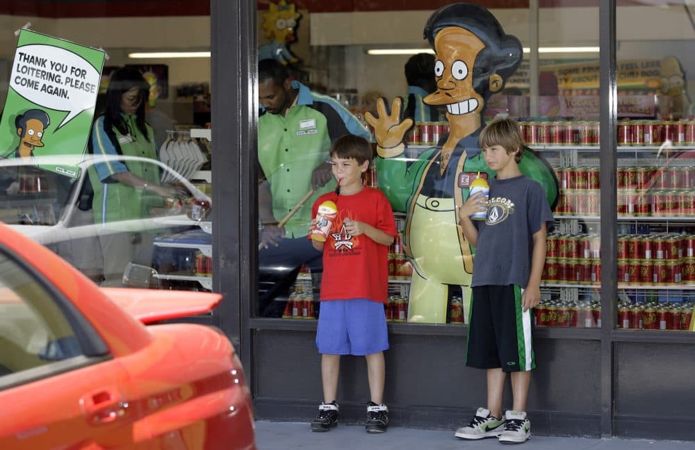 Children pause next top a poster with &quot;The Simpsons&quot; character Apu Nahasapeemapetilon, Jr., outside the 7-Eleven 'Kwik-E-Mart' in Burbank, Calif. Monday, July 2, 2007. (Damian Dovarganes/AP)