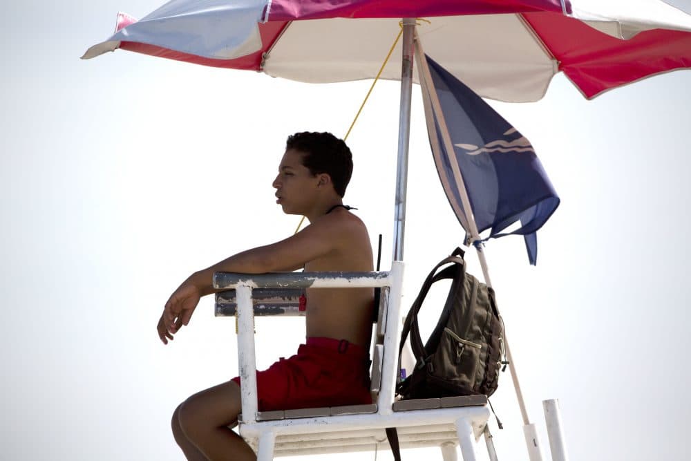 A lifeguard keeps watch at Revere Beach in Revere, Mass., Friday, July 21, 2017, in Revere, Mass. (AP Photo/Michael Dwyer)