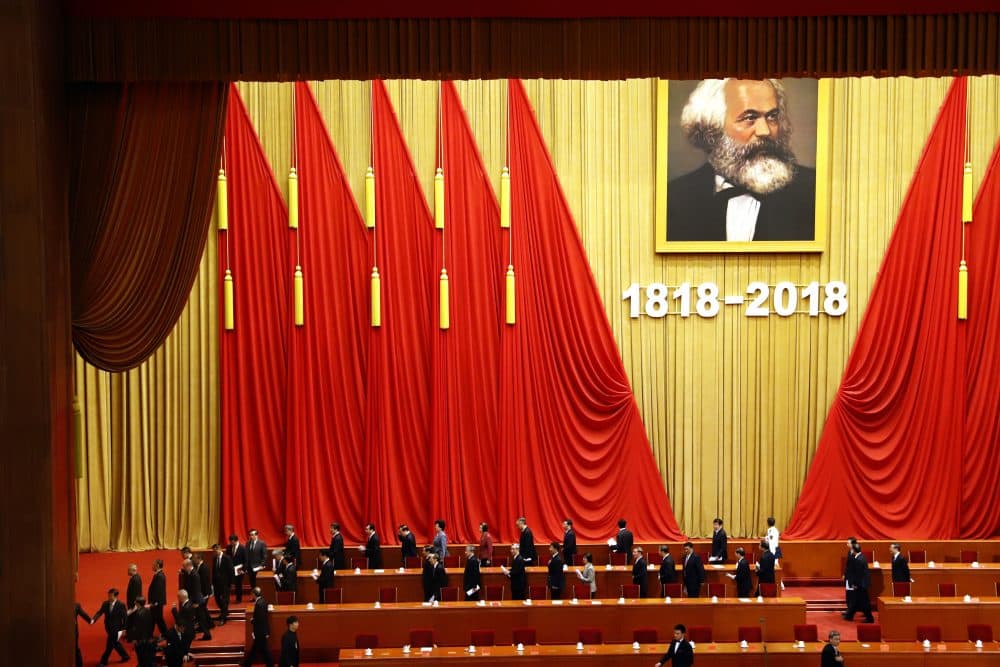 In this May 4, 2018, photo, participants leave after an event to mark the bicentennial of Karl Marx's birth at the Great Hall of the People in Beijing. Abroad, China's President Xi Jinping portrays himself as a robust defender of free markets, yet at home, he's leading a campaign to promote the works of communist philosopher Karl Marx. (Ng Han Guan/AP)