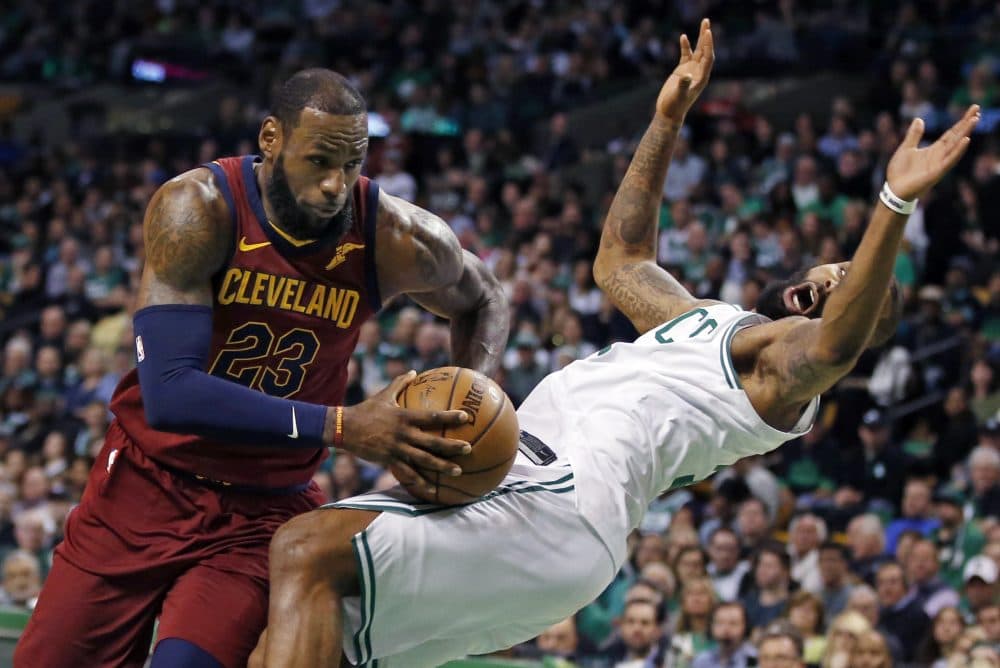 Cleveland Cavaliers forward LeBron James (23) drives against the defense of Boston Celtics forward Marcus Morris during the first quarter of Game 1 of the NBA basketball Eastern Conference Finals, Sunday, May 13, 2018, in Boston. (Michael Dwyer/AP)