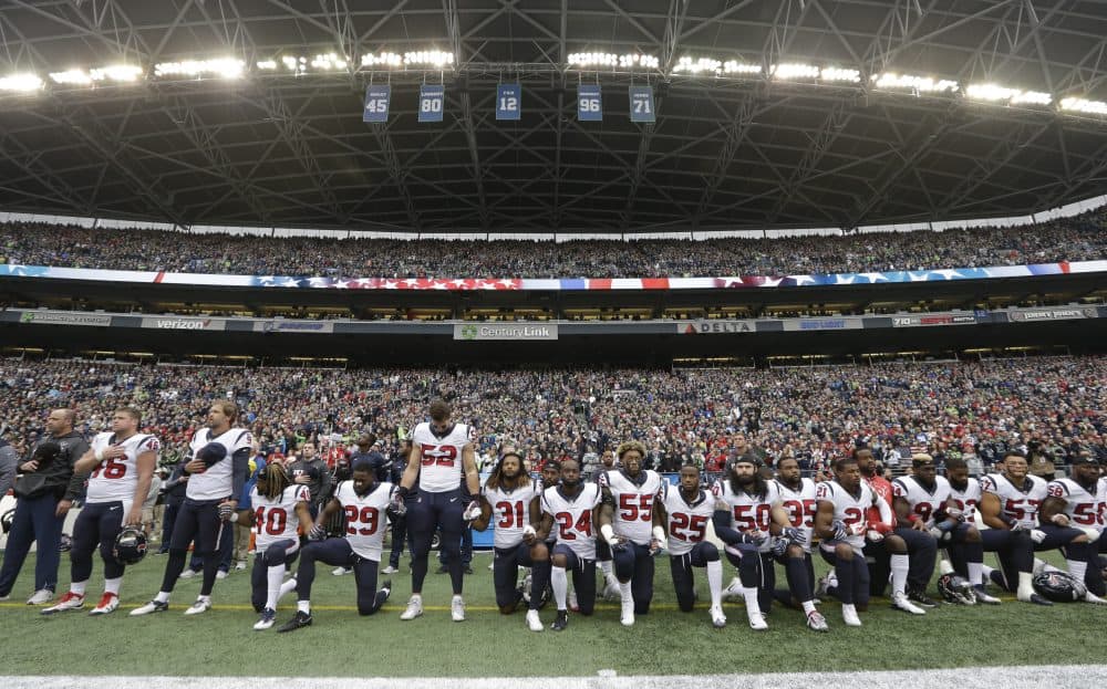 In this Oct. 29, 2017, file photo, Houston Texans players kneel and stand during the singing of the national anthem before an NFL football game against the Seattle Seahawks, in Seattle. NFL owners have approved a new policy aimed at addressing the firestorm over national anthem protests, permitting players to stay in the locker room during the &quot;The Star-Spangled Banner&quot; but requiring them to stand if they come to the field. The decision was announced Wednesday, May 23, 2018, by NFL Commissioner Roger Goodell during the league's spring meeting in Atlanta. (Elaine Thompson/AP)
