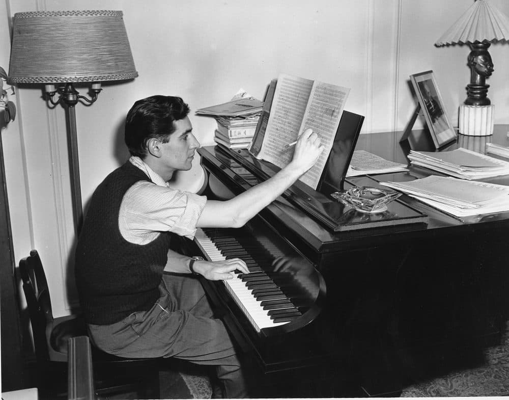 Composer, conductor and pianist Leonard Bernstein works on a score in his apartment. He's in his late 20s in this photograph. (AP)