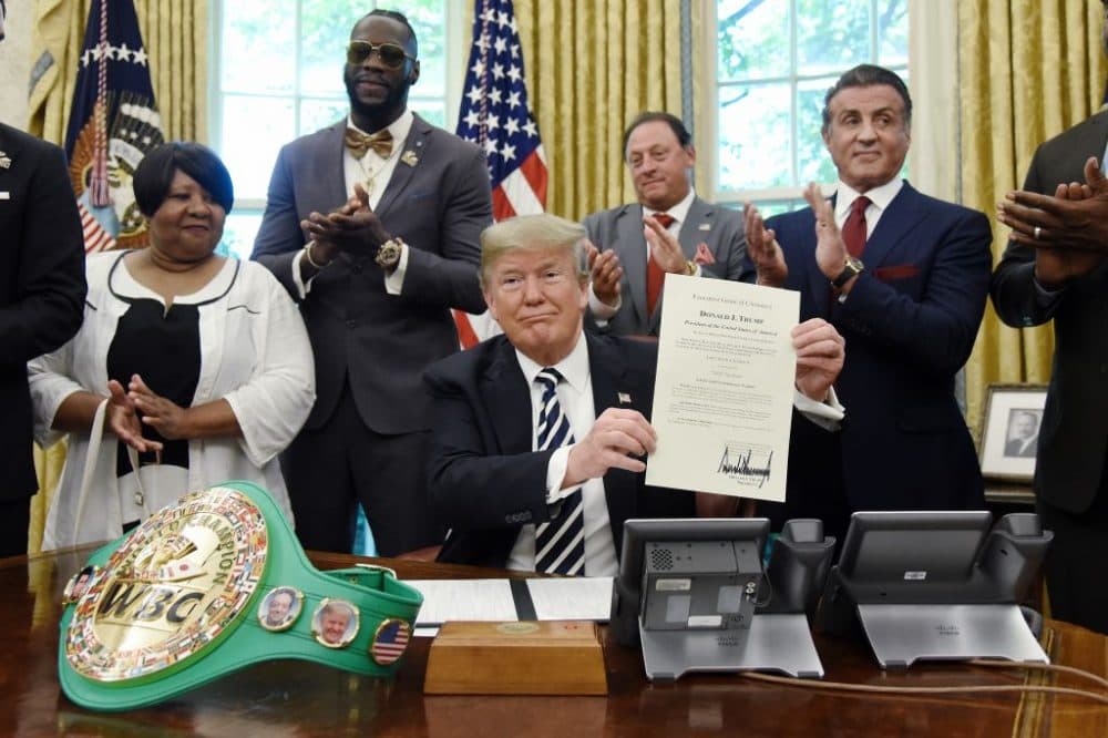 President Donald Trump holds a signed Executive Grant of Clemency for boxer Jack Johnson, May 24, 2018. (Left to right) Linda Haywood, great great niece of Jack Johnson, Deontay Wilder, Keith Frankel, Sylvester Stallone and boxer Lennox Lewis. (Olivier Douliery-Pool/Getty Images)