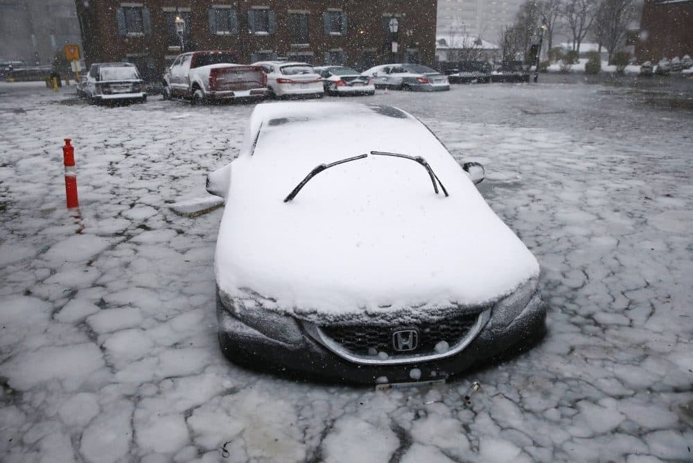 A car sits in floodwaters from Boston Harbor on Long Wharf, during the early January nor'easter. (Michael Dwyer/AP)