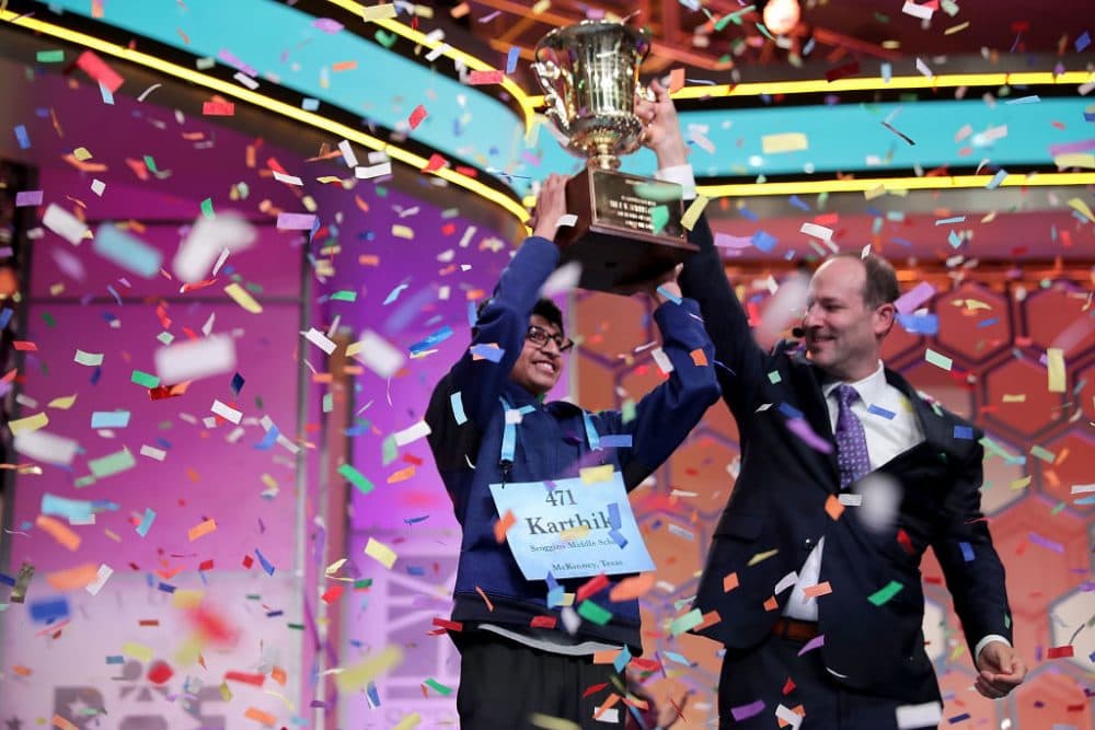Karthik Nemmani (left) poses with the championship trophy and E.W. Scripps Company CEO Adam Symson after correctly spelling &quot;koinonia&quot; to win the 91st Scripps National Spelling Bee. (Chip Somodevilla/Getty Images)