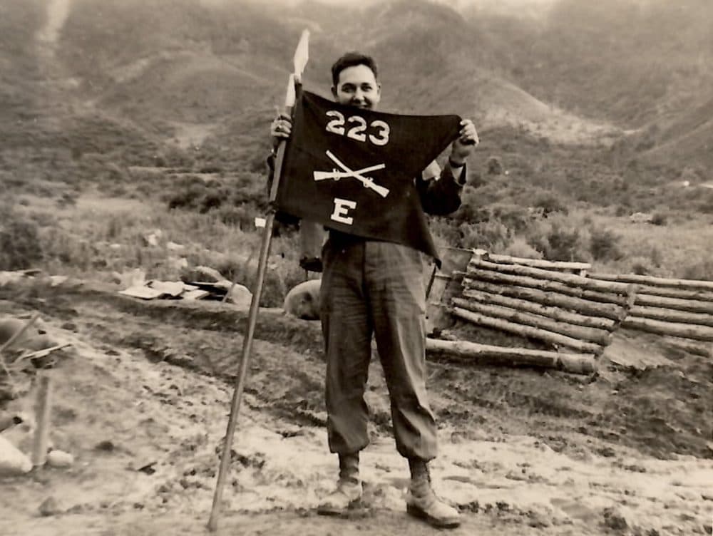 John Cort poses with his company's flag at the so-called Punchbowl, in Korea. (Courtesy John Cort)