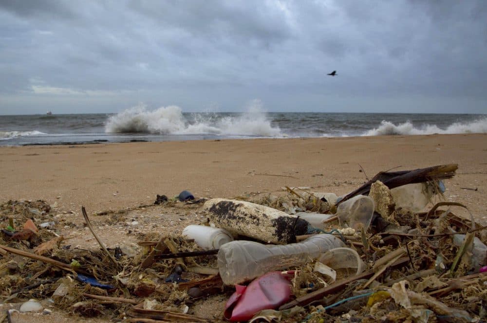 In this Aug. 13, 2015, file photo, a plastic bottle lies among other debris washed ashore on the Indian Ocean beach in Uswetakeiyawa, north of Colombo, Sri Lanka. (Gemunu Amarasinghe/AP)