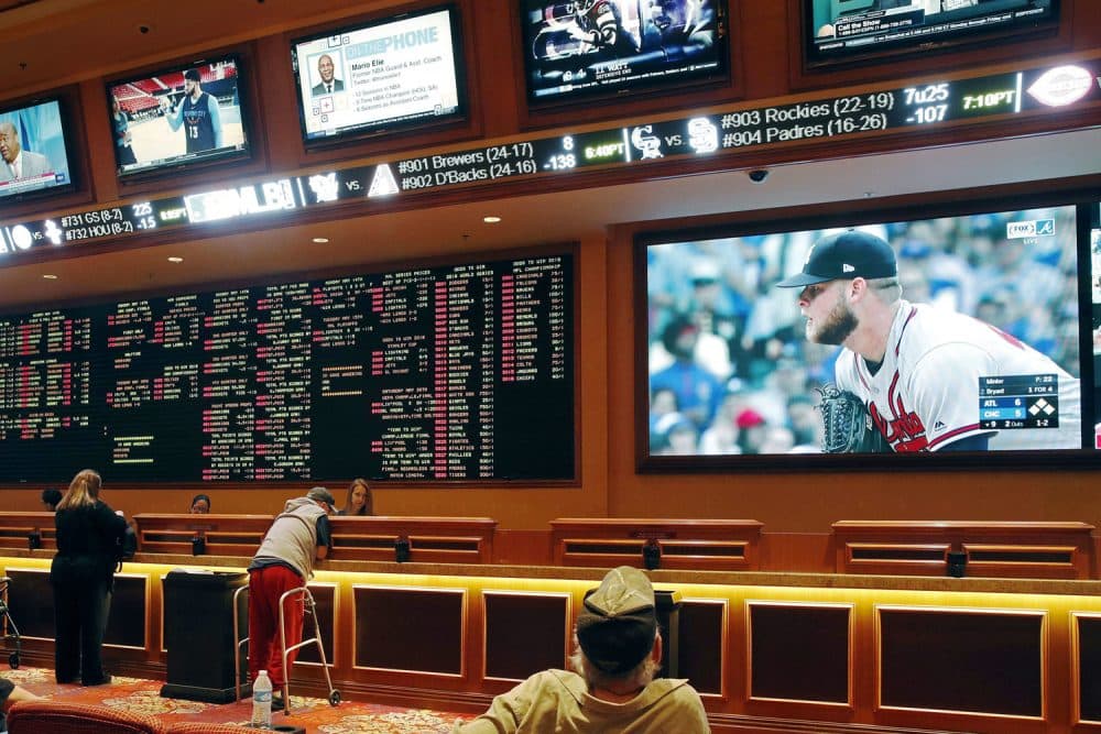 In this Monday, May 14, 2018 file photo, people make bets in the sports book area of the South Point Hotel and Casino in Las Vegas. (John Locher/AP)
