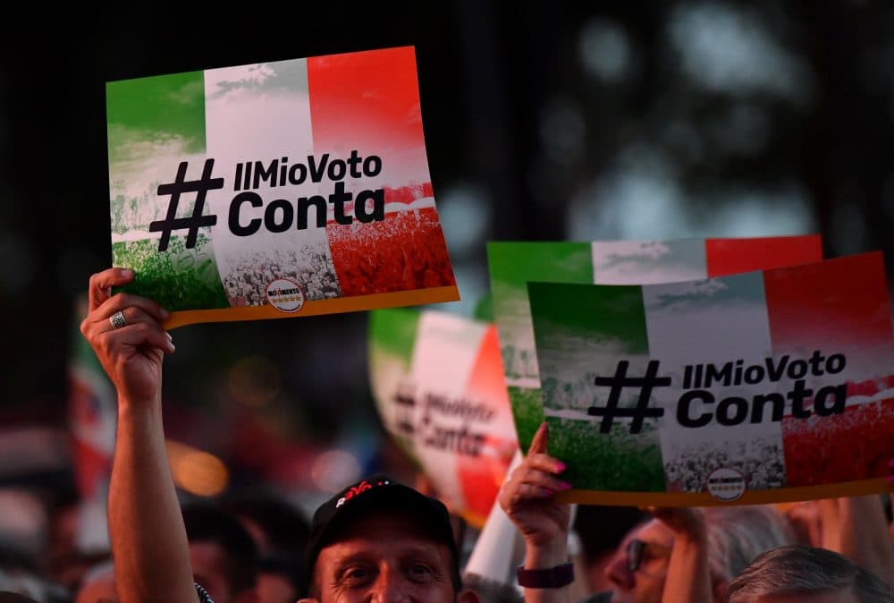 M5S supporters hold banners reading &quot;My vote counts&quot; during a meeting to celebrate Italy's new government in Rome, on June 2, 2018. (Alberto Pizzoli/AFP/Getty Images)