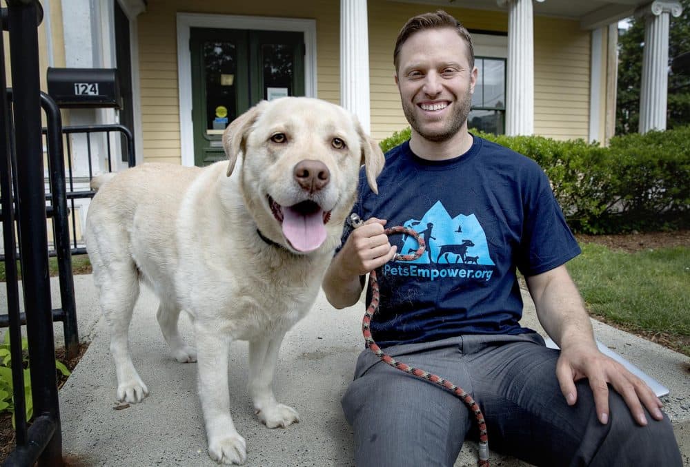 PetsEmpower's founder and executive director, Jordan Ross, with his dog Kariya. (Robin Lubbock/WBUR)