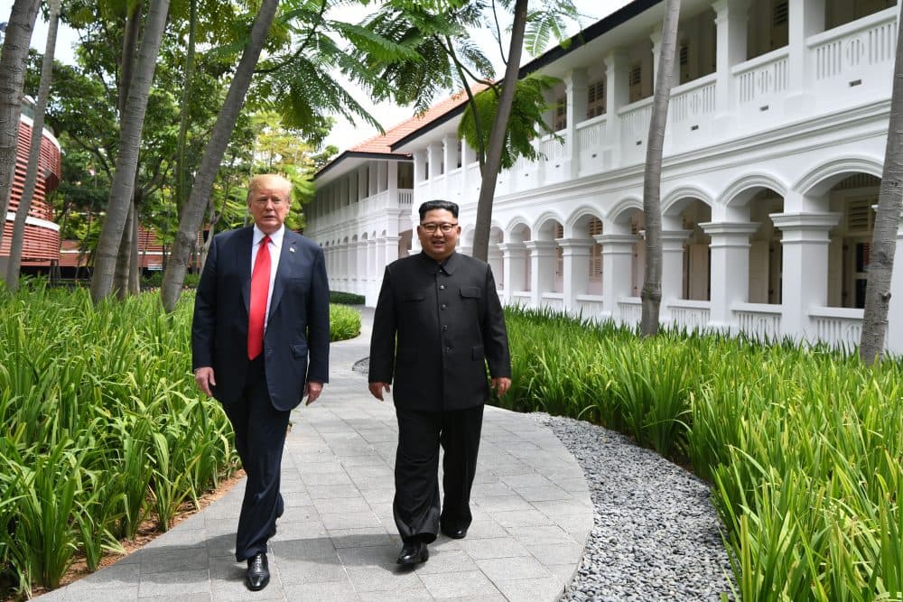 North Korea's leader Kim Jong Un walks with President Trump during a break in talks at their historic U.S.-North Korea summit, at the Capella Hotel on Sentosa island in Singapore on June 12, 2018. (Anthony Wallace/AFP/Getty Images)