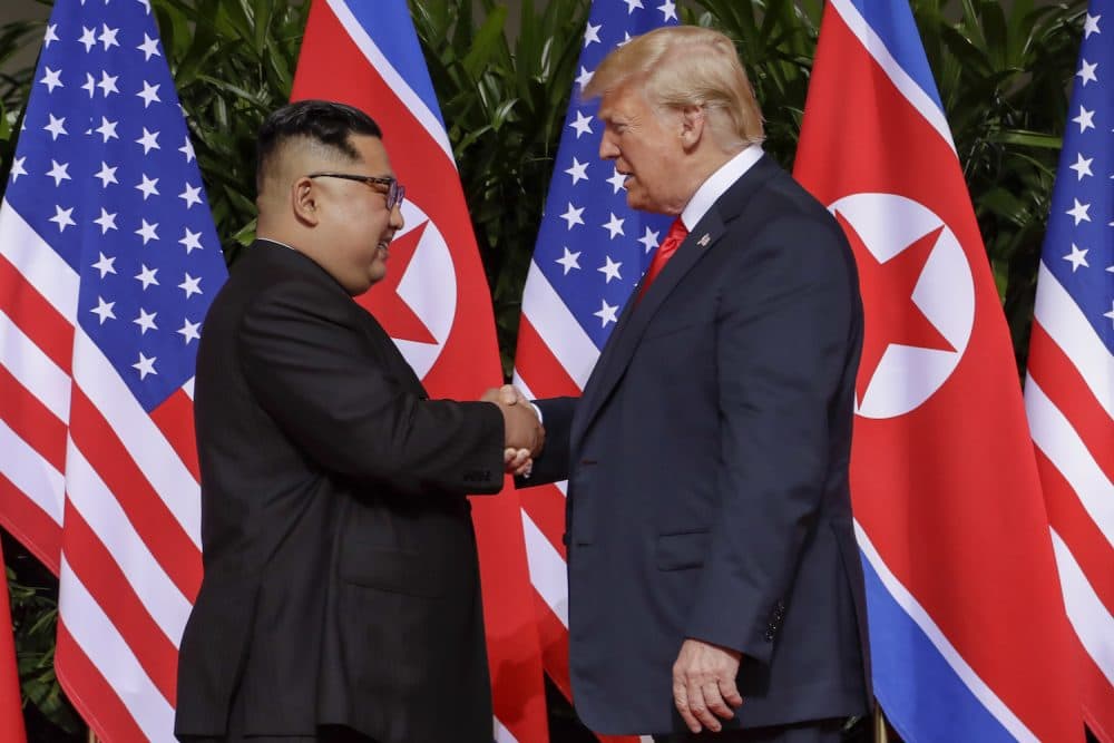 U.S. President Donald Trump shakes hands with North Korea leader Kim Jong Un at the Capella resort on Sentosa Island Tuesday, June 12, 2018 in Singapore. (Evan Vucci/AP)