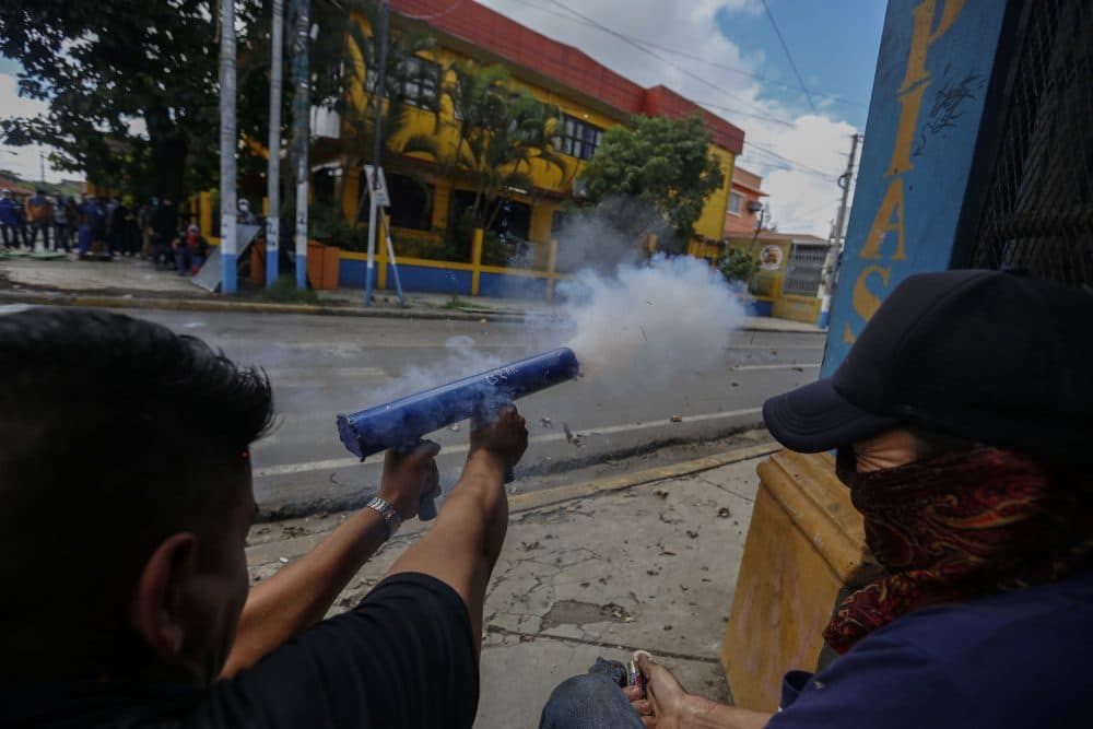 Anti-government protesters fire homemade mortars at police and government supporters in Jinotepe, Nicaragua, Tuesday, June 12, 2018. Protests began in mid-April in response to changes to the social security system, but expanded to call for President Daniel Ortega's exit from power. (Alfredo Zuniga/AP)