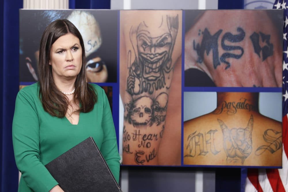 White House press secretary Sarah Huckabee Sanders stands in front of pictures of MS-13 gang tattoos during a press briefing at the White House in Washington, Thursday, July 27, 2017. (Alex Brandon/AP)