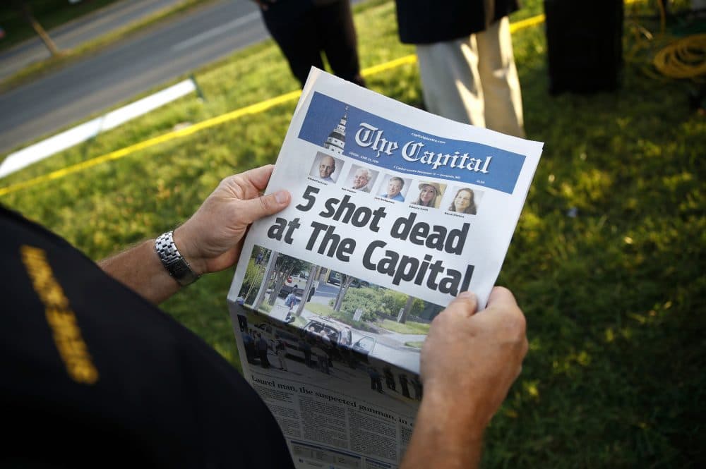 Steve Schuh, county executive of Anne Arundel County, holds a copy of The Capital Gazette near the scene of a shooting at the newspaper's office, Friday, June 29, 2018, in Annapolis, Md. A man armed with smoke grenades and a shotgun attacked journalists in the building Thursday, killing several people before police quickly stormed the building and arrested him, police and witnesses said. (Patrick Semansky/AP)